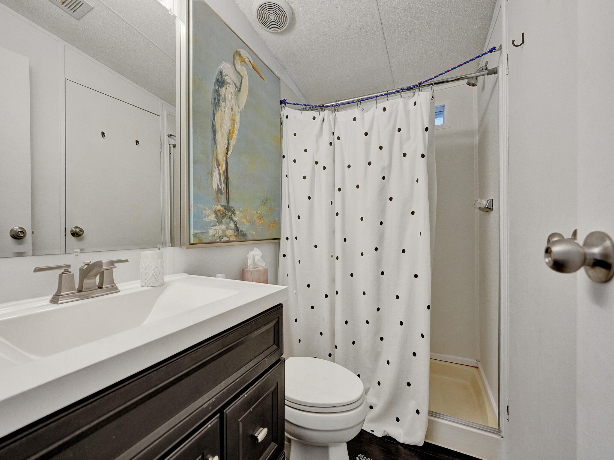 14609 Sunset Drive Delray Beach, FL 33445 - Photo 21 of 50 a bathroom with a sink a toilet and shower curtain