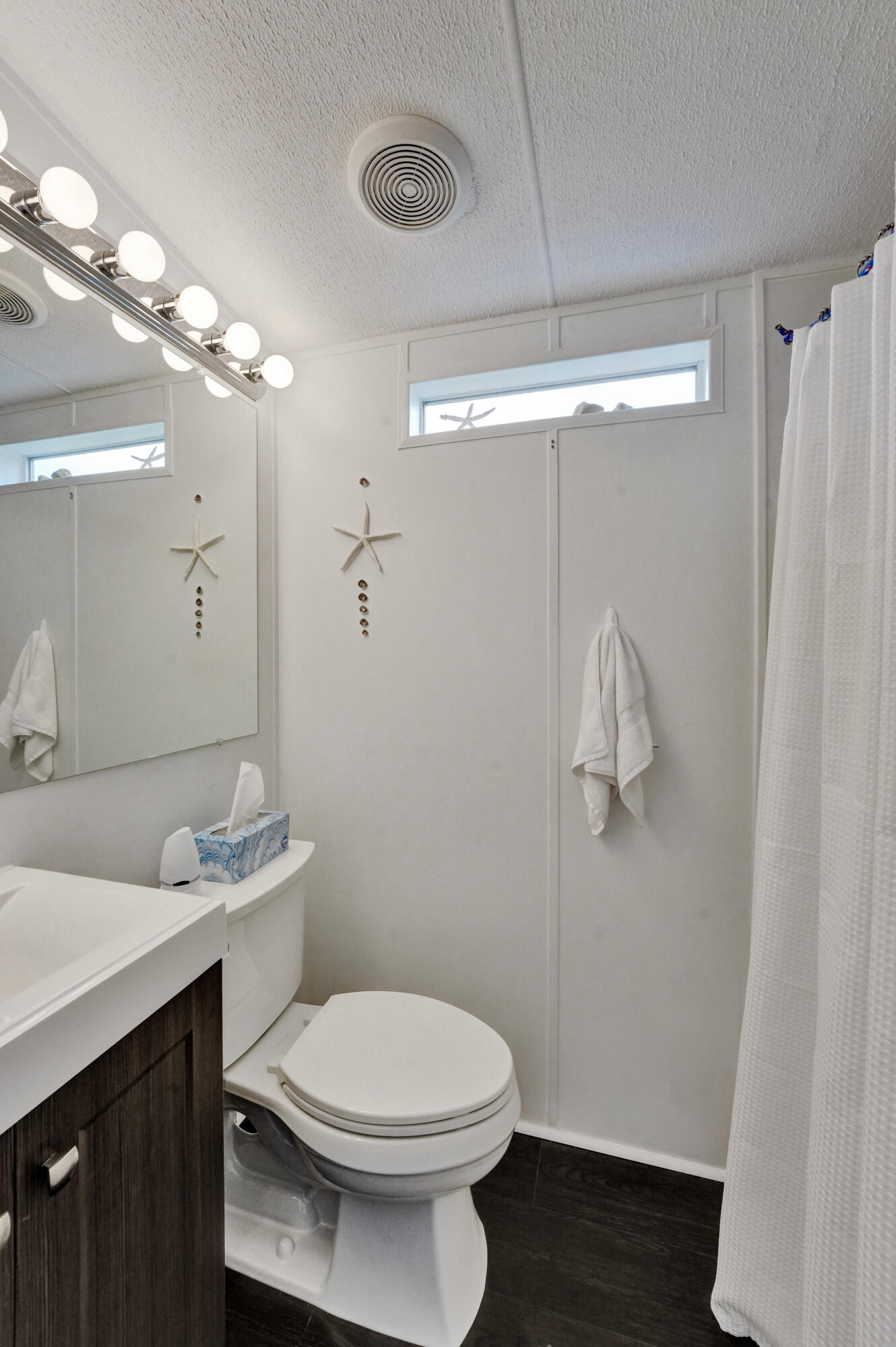 14609 Sunset Drive Delray Beach, FL 33445 - Photo 32 of 50 a bathroom with a sink a toilet a mirror and shower