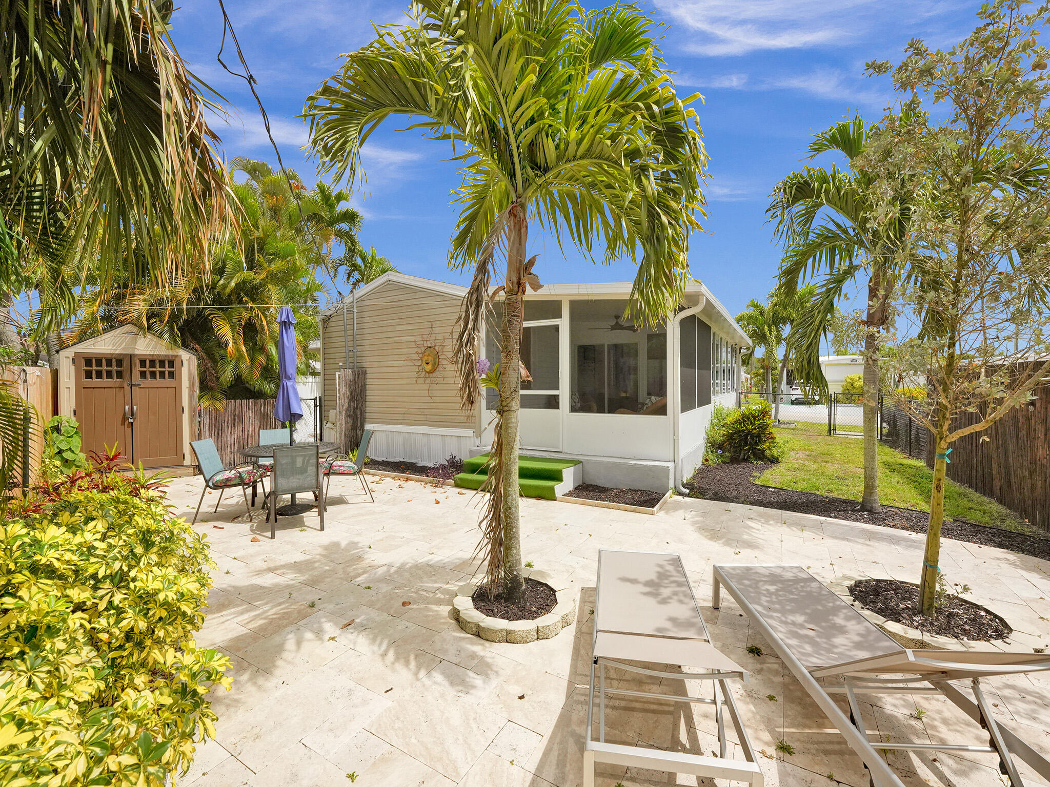 14609 Sunset Drive Delray Beach, FL 33445 - Photo 6 of 50 a front view of a house with garden and patio