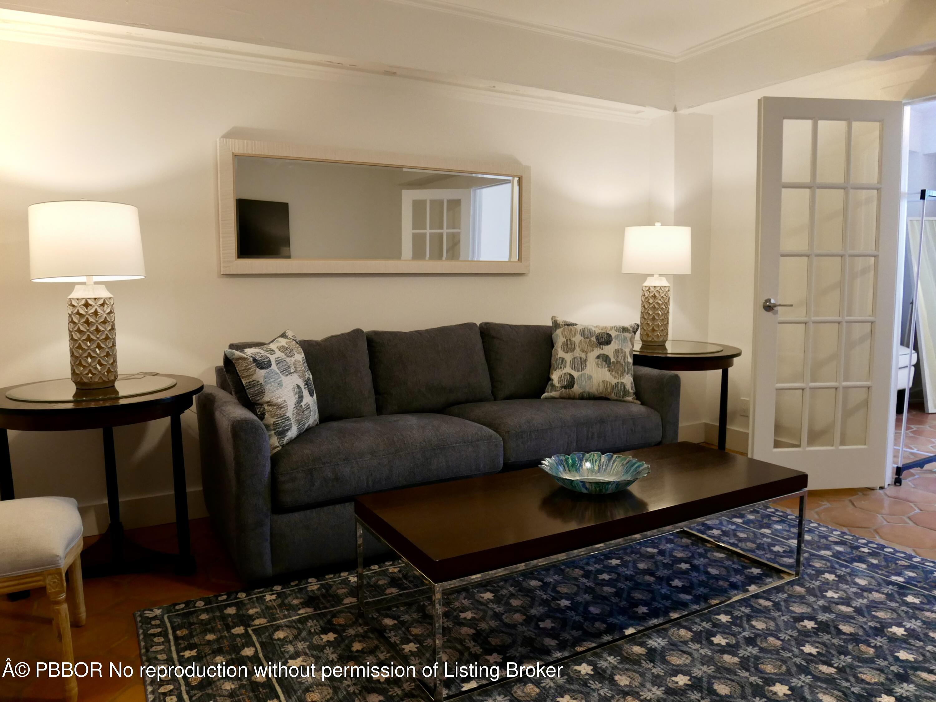 235 Sunrise Avenue, Unit 1107 & 1108 Palm Beach, FL 33480 - Photo 13 of 28 a living room with furniture a lamp a rug and a table