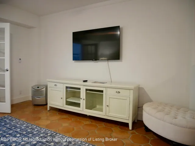 a view of a livingroom with furniture and a flat screen tv