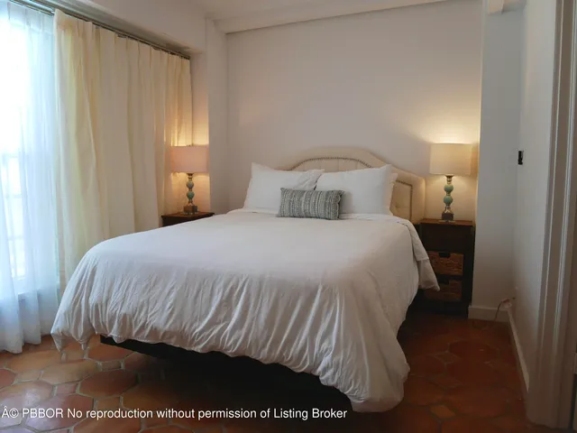 a bedroom with a bed and a night stand