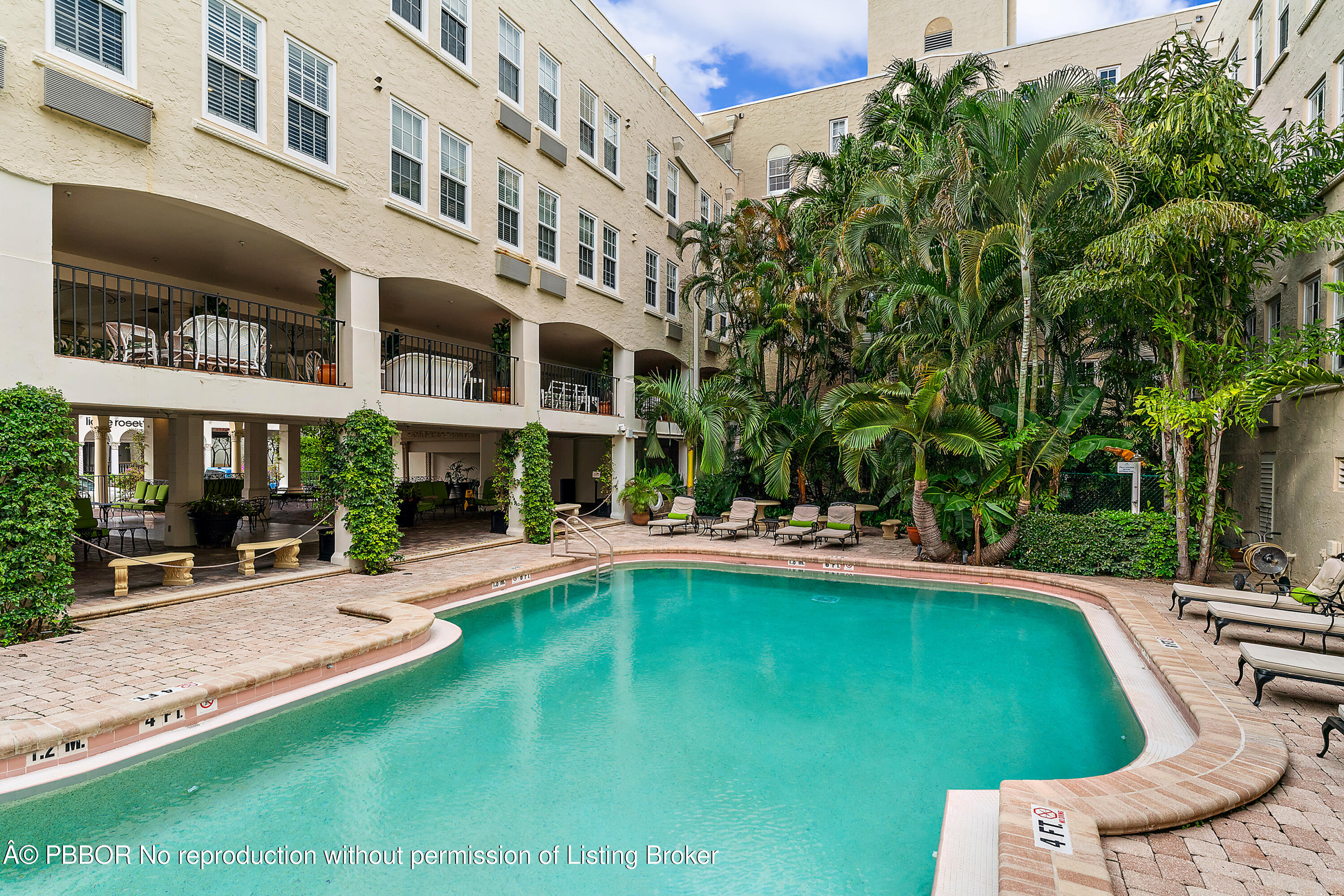 235 Sunrise Avenue, Unit 1107 & 1108 Palm Beach, FL 33480 - Photo 18 of 28 a view of a swimming pool with lawn chairs and plants