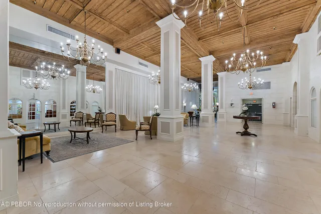 a view of hall with living room and chandelier