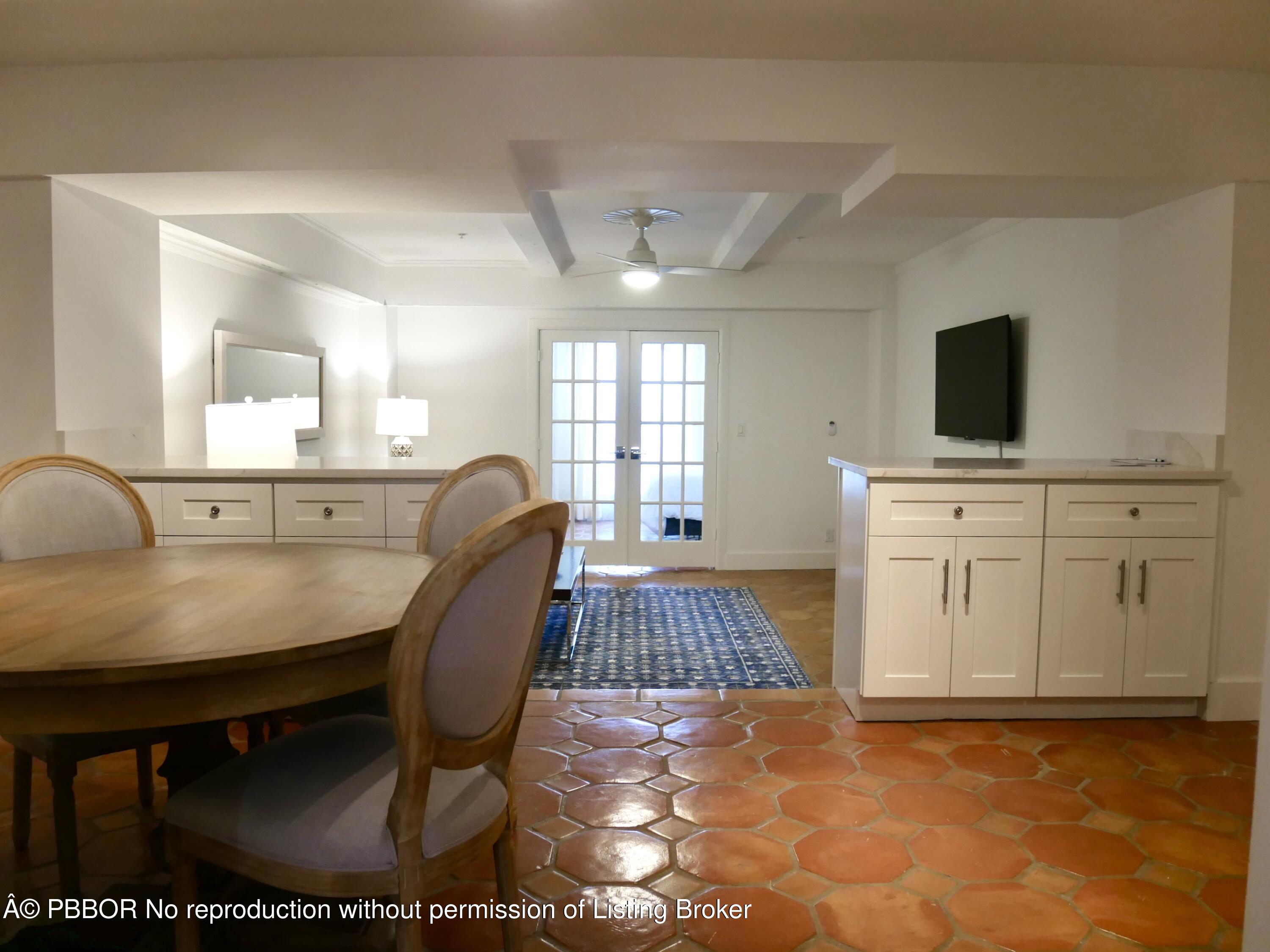 235 Sunrise Avenue, Unit 1107 & 1108 Palm Beach, FL 33480 - Photo 24 of 28 a living room with furniture a flat screen tv and a fireplace