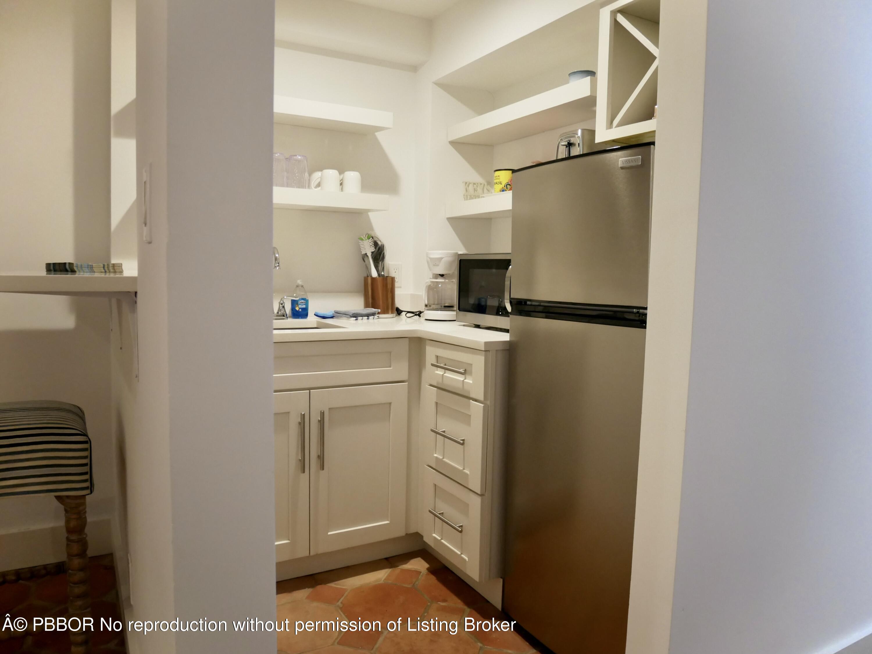 235 Sunrise Avenue, Unit 1107 & 1108 Palm Beach, FL 33480 - Photo 26 of 28 a kitchen with a refrigerator a stove a washer and dryer