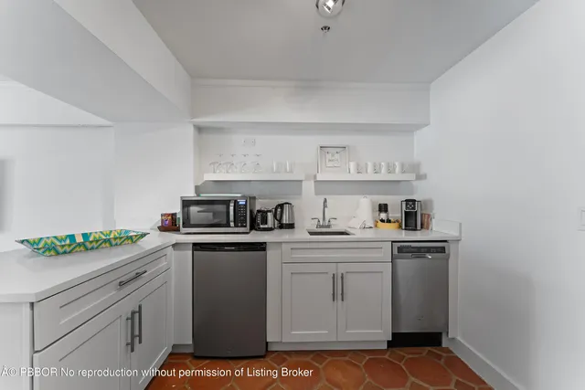 a kitchen with a stove sink and cabinets