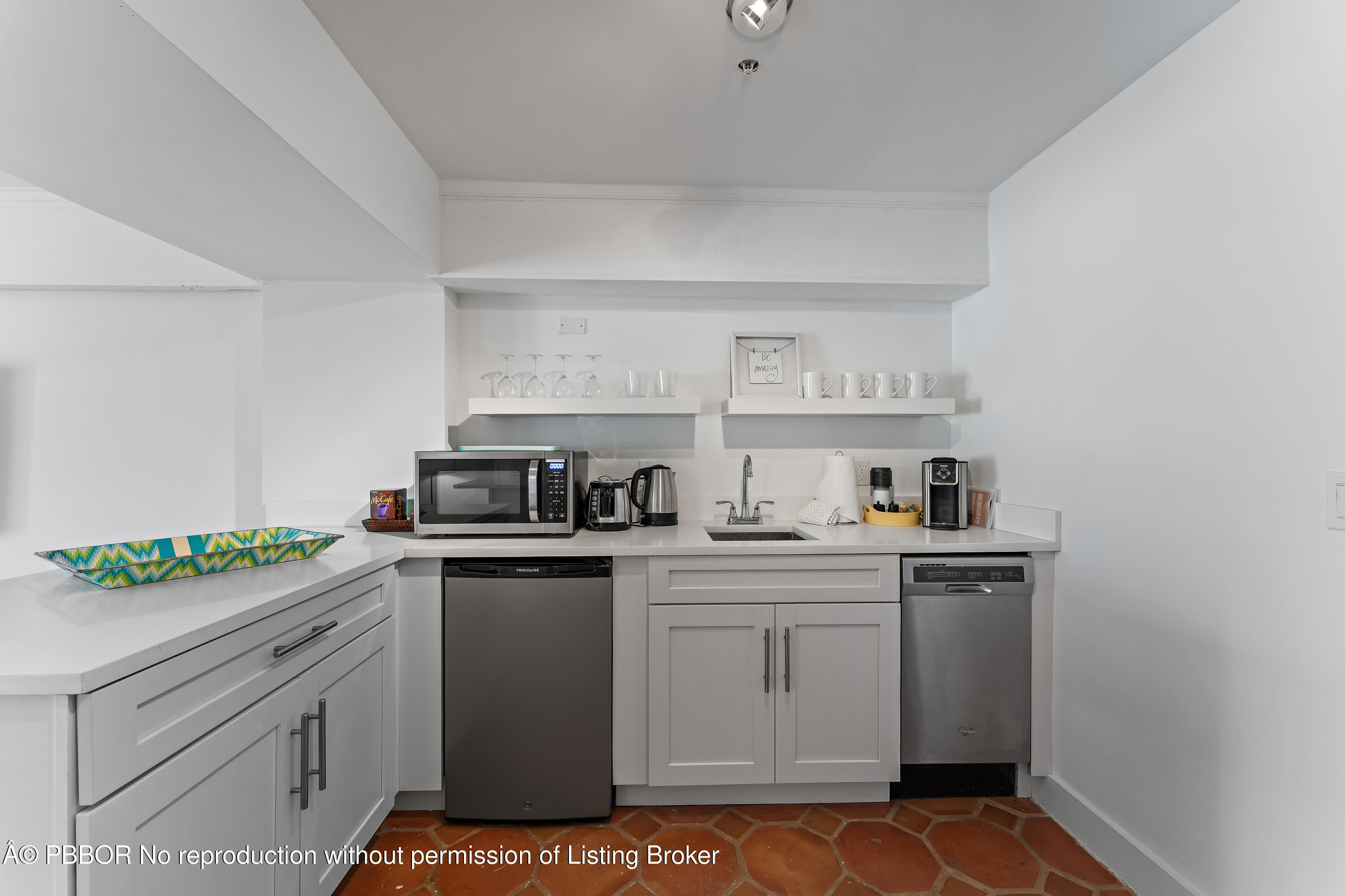 235 Sunrise Avenue, Unit 1107 & 1108 Palm Beach, FL 33480 - Photo 9 of 28 a kitchen with a stove sink and cabinets