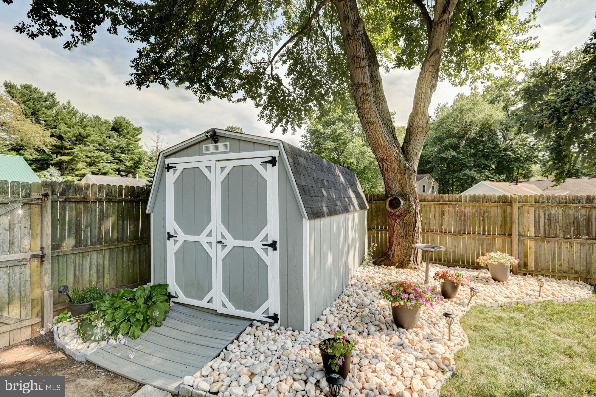 6 3 Rivers Drive Newark, DE 19702 - Photo 62 of 63 Charming shed nestled in a serene garden.