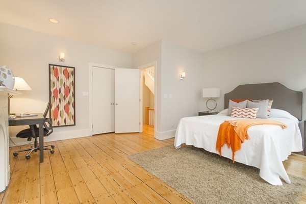 45 Lawrence Street, Unit 2 Boston, MA 02116 - Photo 6 of 10 a bedroom with a bed and wooden floor