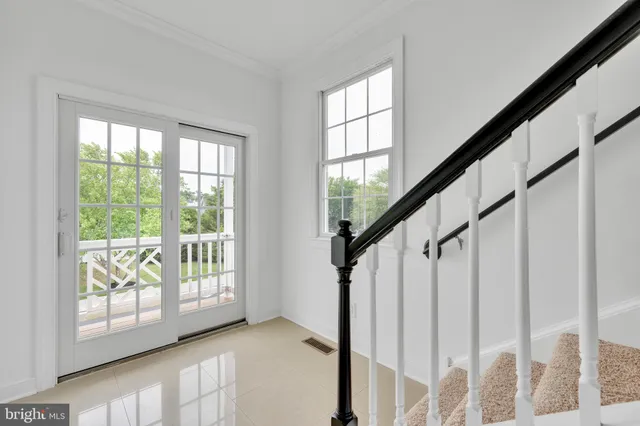 a view of an entryway with wooden floor and door
