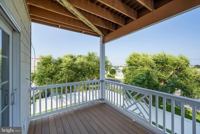 a view of a chair and table on the roof deck