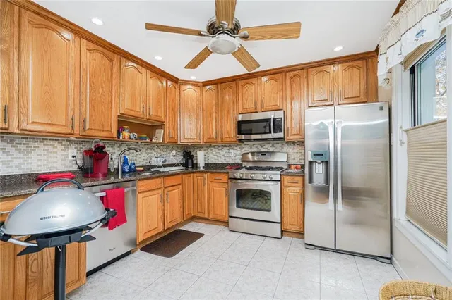 a kitchen with furniture and a window