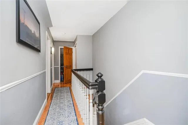a spacious bedroom with a bed and wooden floor