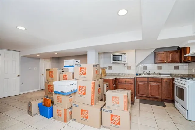 a kitchen with a sink appliances and cabinets
