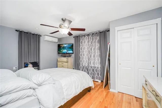 a bedroom with a large bed and a chandelier