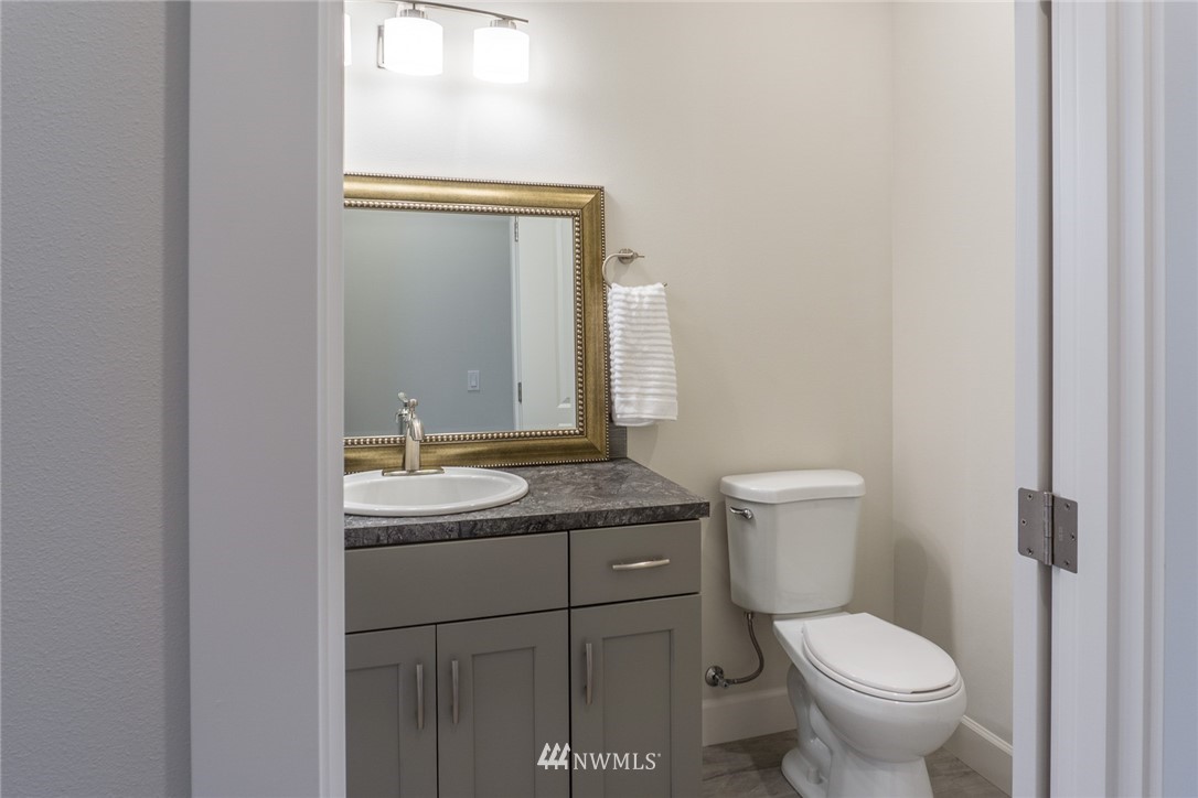 1803 Watkins Road Freeland, WA 98249 - Photo 17 of 25 a bathroom with a granite countertop toilet and a sink