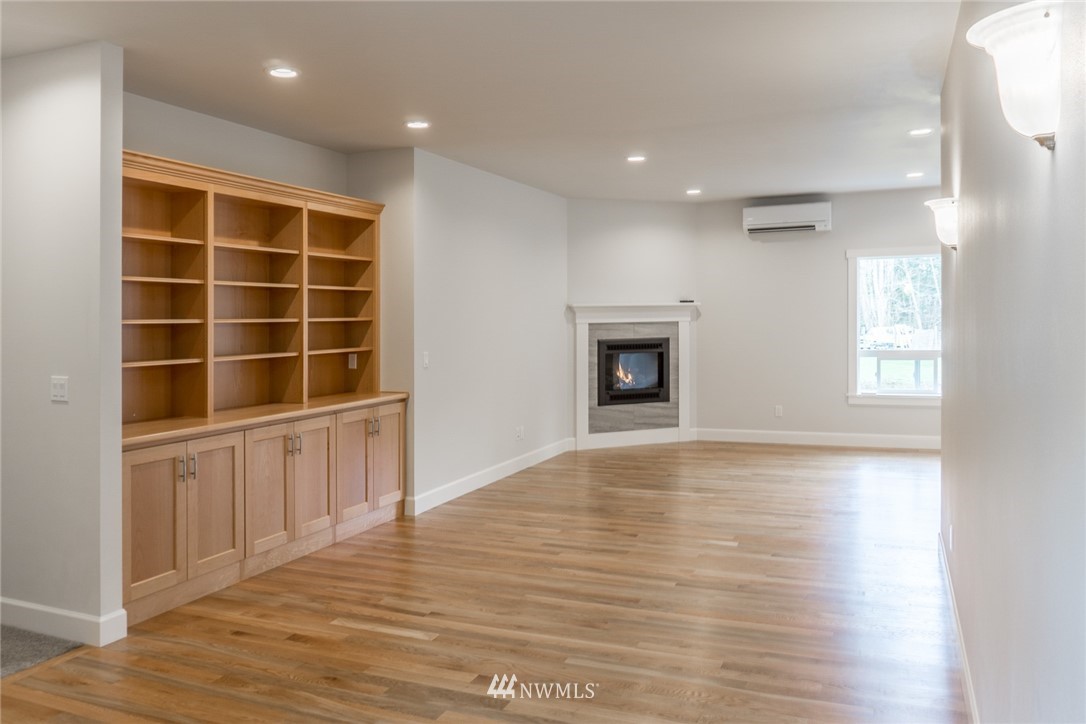 1803 Watkins Road Freeland, WA 98249 - Photo 3 of 25 a view of an empty room with a window and wooden floor
