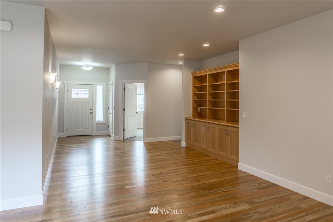 1803 Watkins Road Freeland, WA 98249 - Photo 5 of 25 a view of an empty room with wooden floor and a window