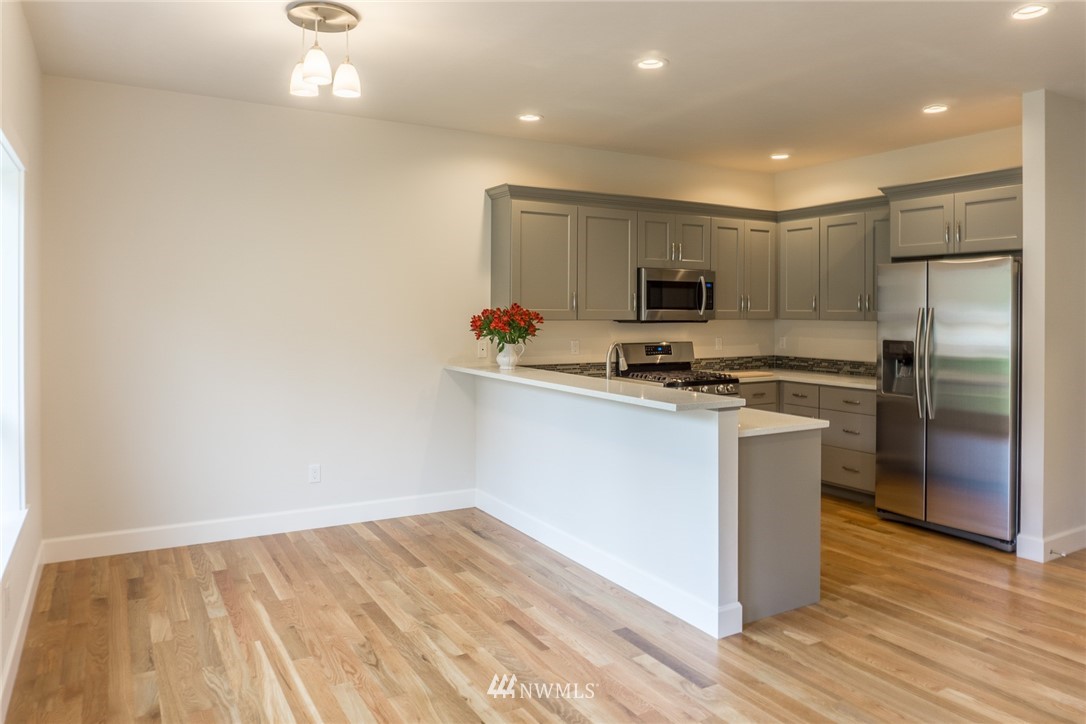 1803 Watkins Road Freeland, WA 98249 - Photo 8 of 25 a kitchen with a refrigerator and a stove top oven