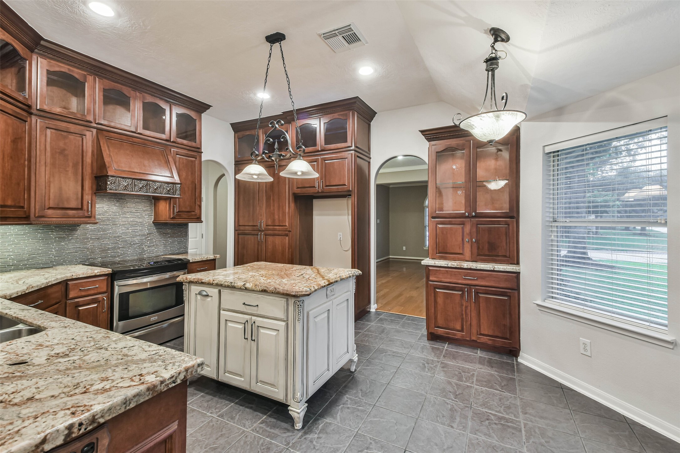 20942 Wind Field Lane Spring, TX 77379 - Photo 19 of 46 a kitchen with stainless steel appliances granite countertop a stove oven and a refrigerator