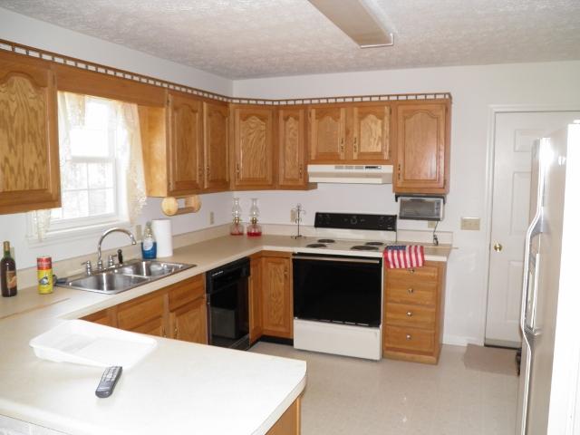 340 Leslie Jamie Road Manchester, TN 37355 - Photo 3 of 10 Kitchen features oak cabinetry and plenty of counter space.