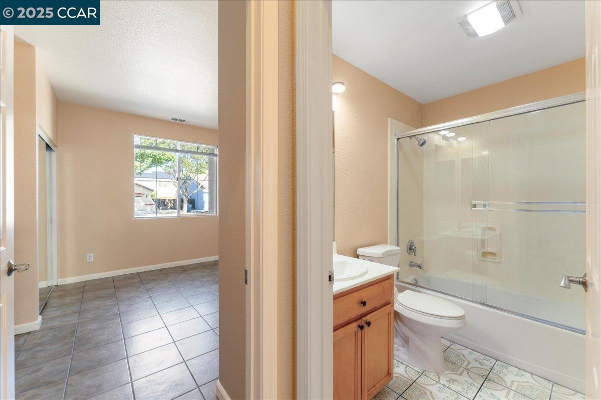 4651 Shetland Way Antioch, CA 94531 - Photo 11 of 34 a bathroom with a granite countertop toilet a sink and bathtub