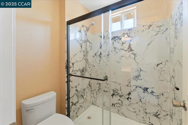 a white toilet sitting next to a shower curtain