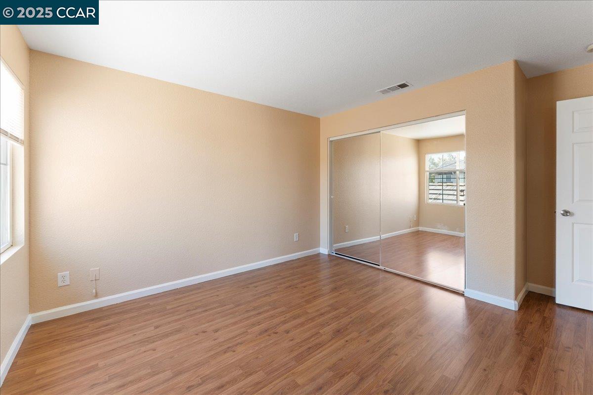 4651 Shetland Way Antioch, CA 94531 - Photo 17 of 34 an empty room with wooden floor & windows