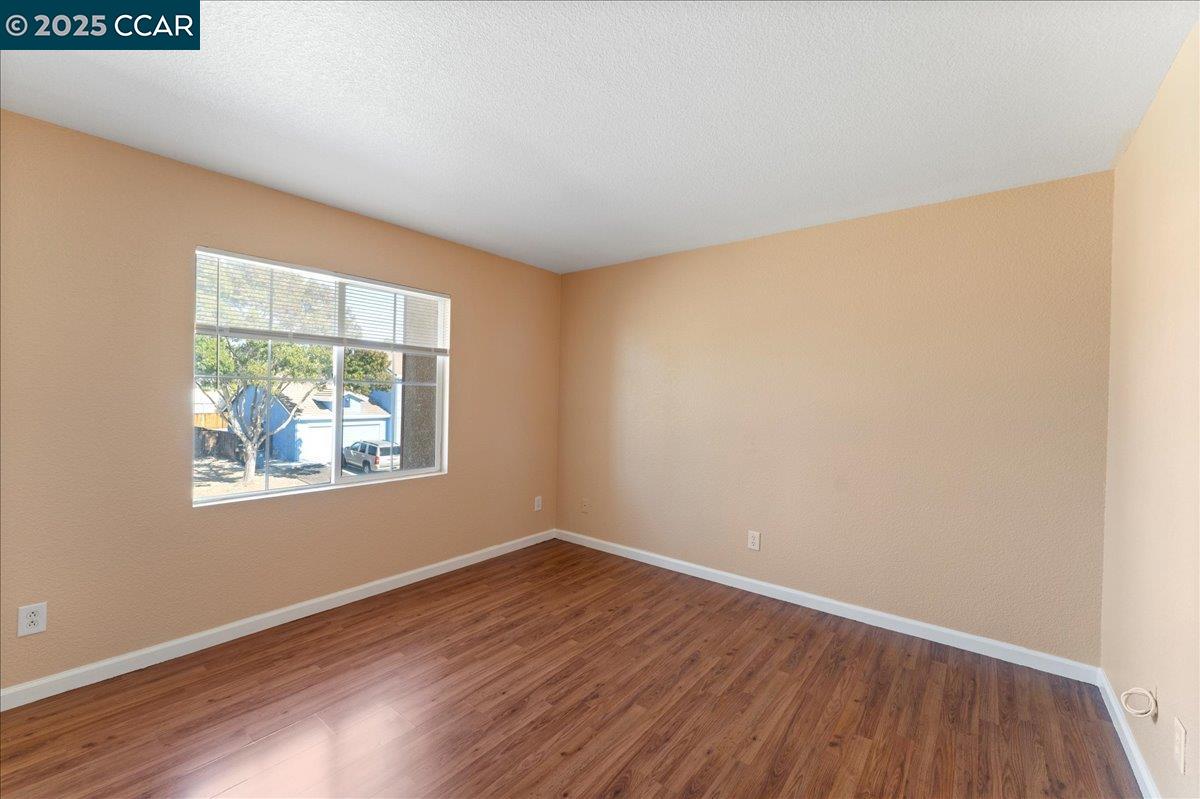 4651 Shetland Way Antioch, CA 94531 - Photo 19 of 34 an empty room with wooden floor and a window