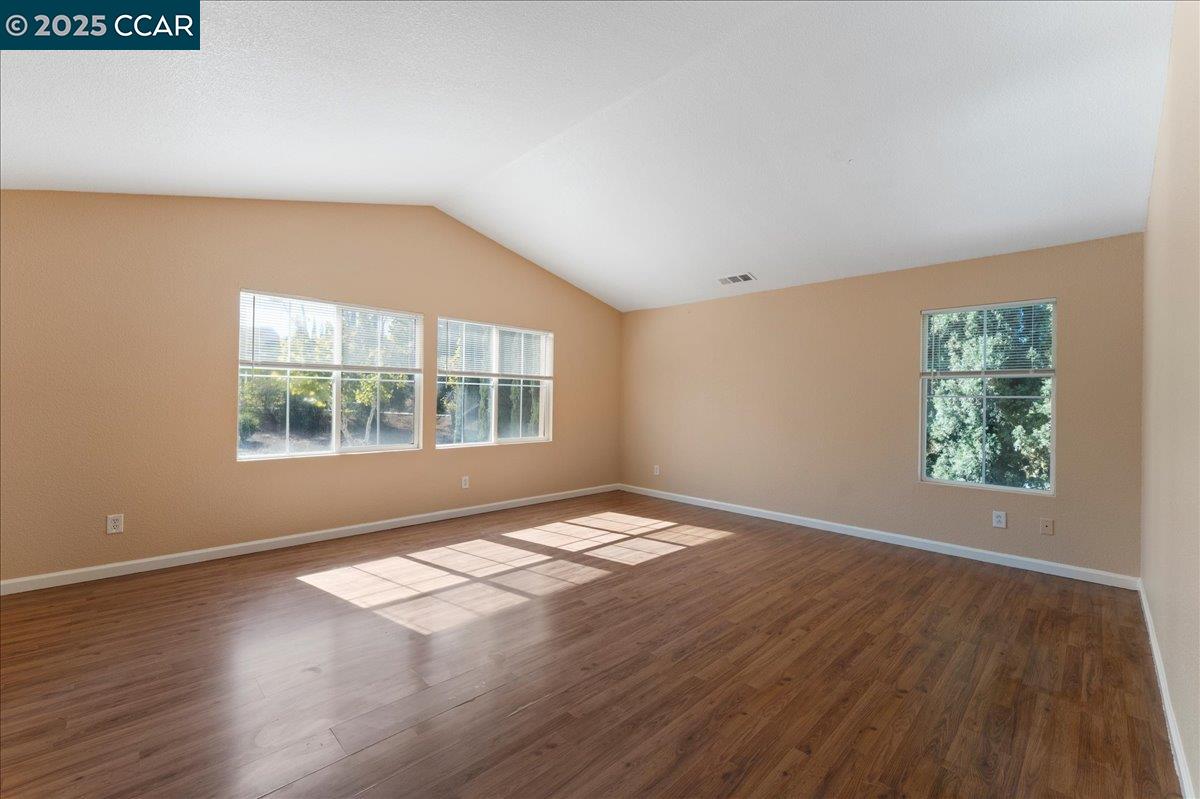 4651 Shetland Way Antioch, CA 94531 - Photo 20 of 34 an empty room with wooden floor and windows