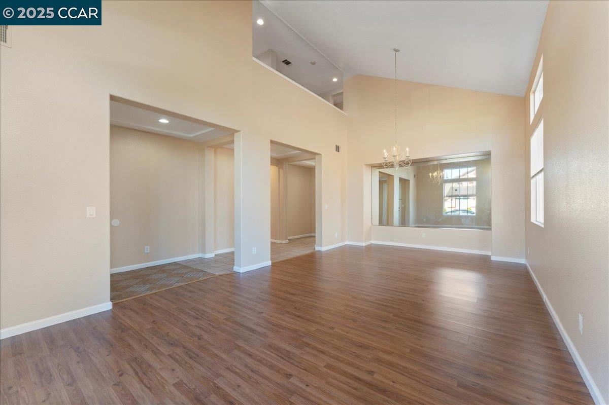 4651 Shetland Way Antioch, CA 94531 - Photo 2 of 34 an empty room with wooden floor and windows