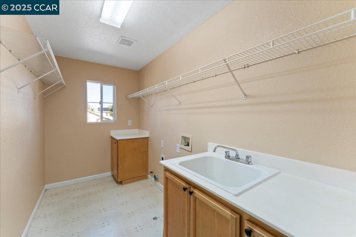 4651 Shetland Way Antioch, CA 94531 - Photo 25 of 34 a utility room with a sink dryer and washer
