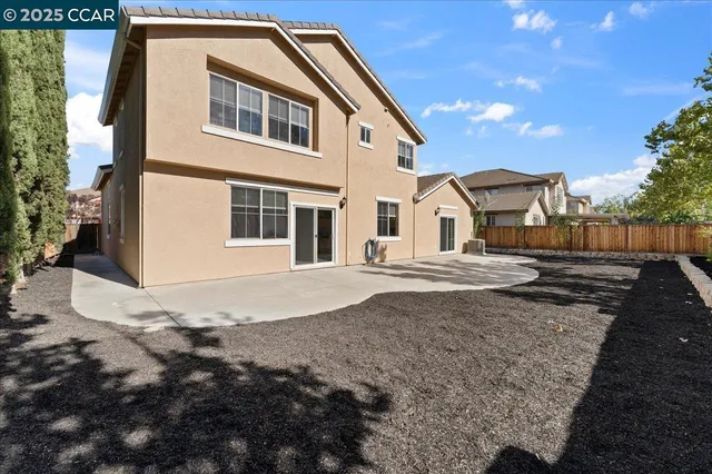 a view of a white house with a yard