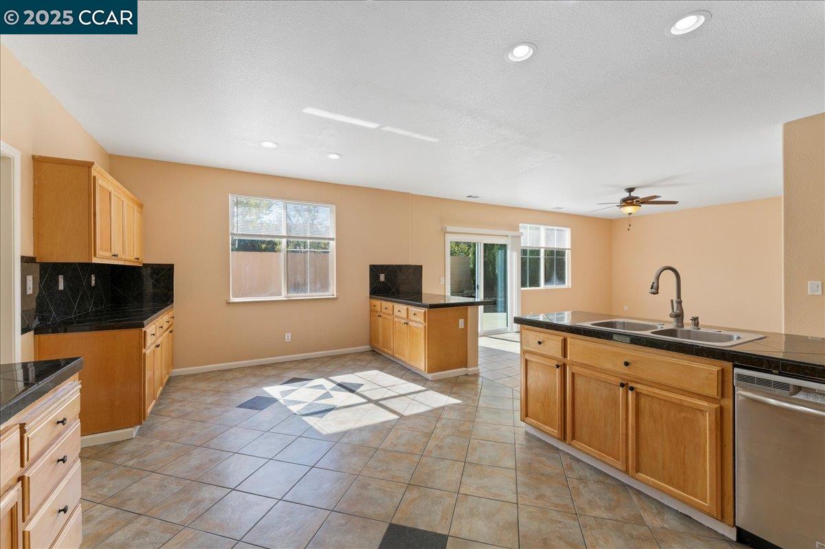 4651 Shetland Way Antioch, CA 94531 - Photo 9 of 34 a kitchen with granite countertop a sink and a stove top oven