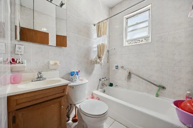 a bathroom with a sink toilet vanity and bathtub