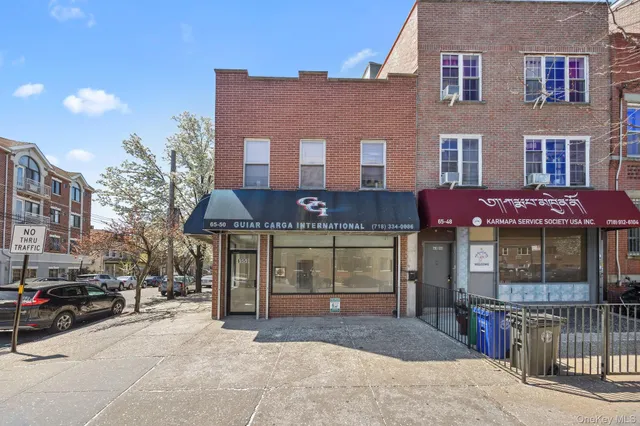 a front view of a building with parking space