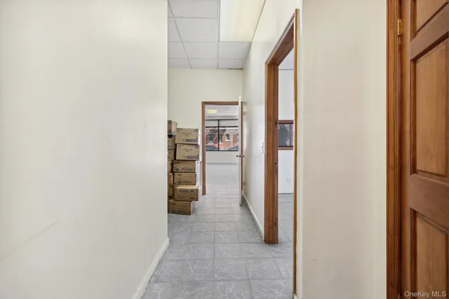 a view of a hallway with wooden shelves