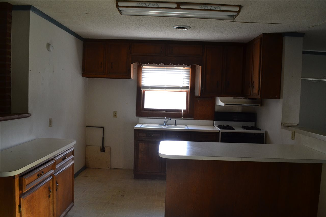 4711 Bragg Road Durham, NC 27704 - Photo 24 of 25 Kitchen has gas range, lots of cabinets and island / bar, open floor plan Kitchen