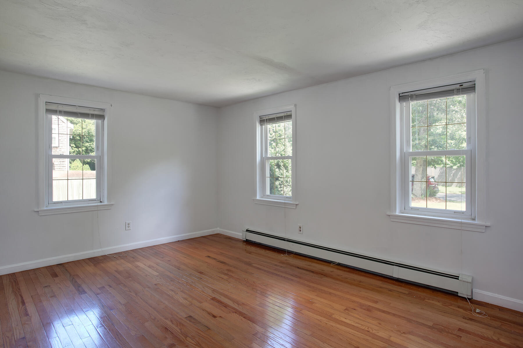 55 Edgewater Road Mashpee, MA 02649 - Photo 11 of 21 a view of an empty room with wooden floor and a window