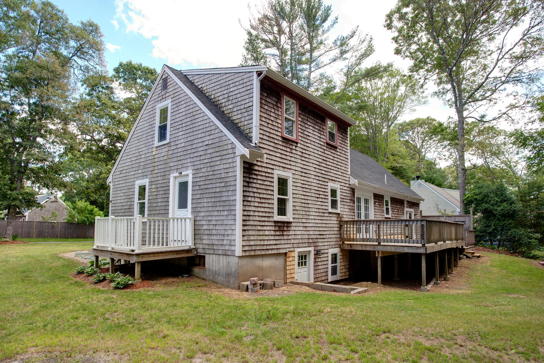 55 Edgewater Road Mashpee, MA 02649 - Photo 17 of 21 a view of a house with a yard and sitting area