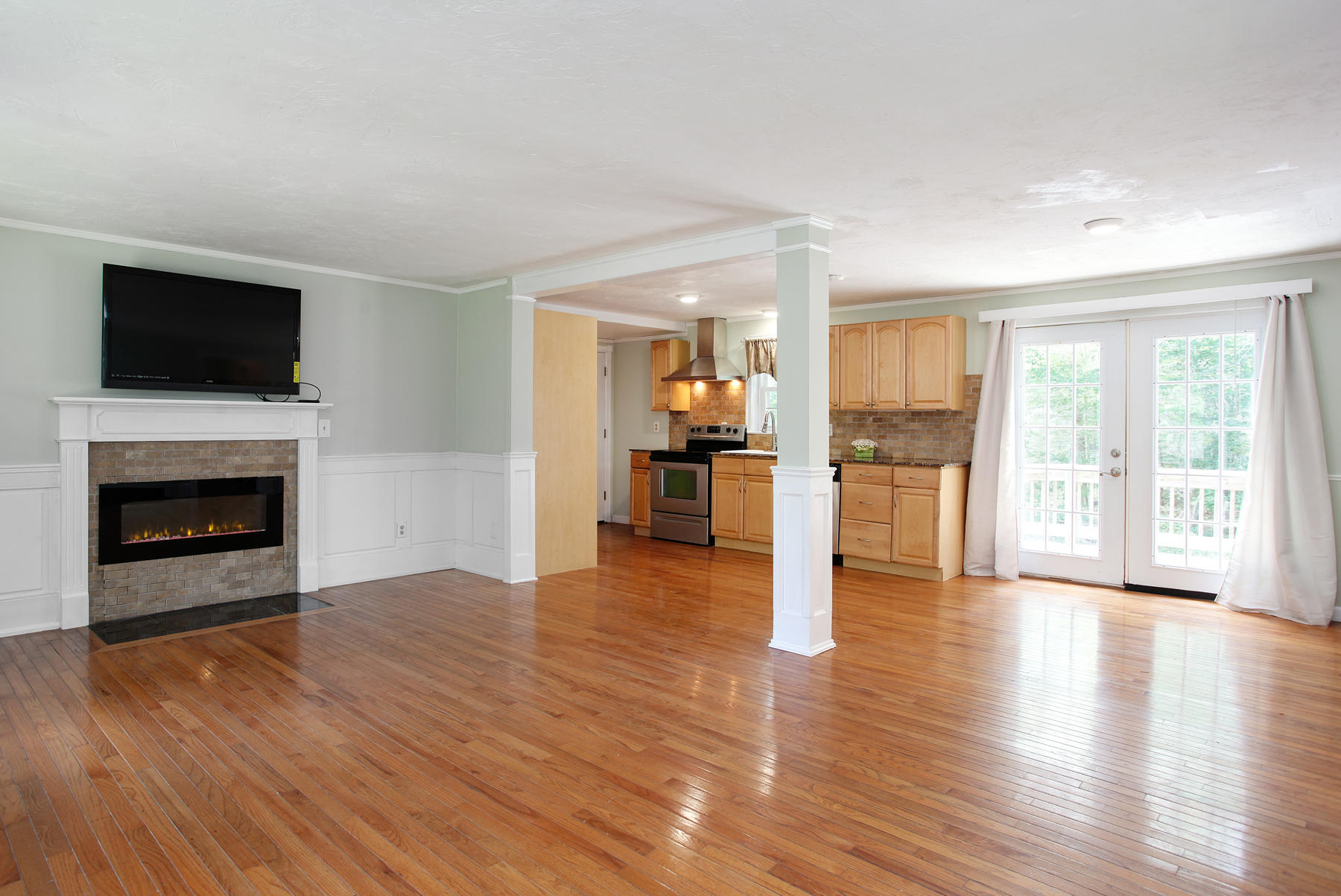 55 Edgewater Road Mashpee, MA 02649 - Photo 4 of 21 a view of empty room with wooden floor and a fireplace