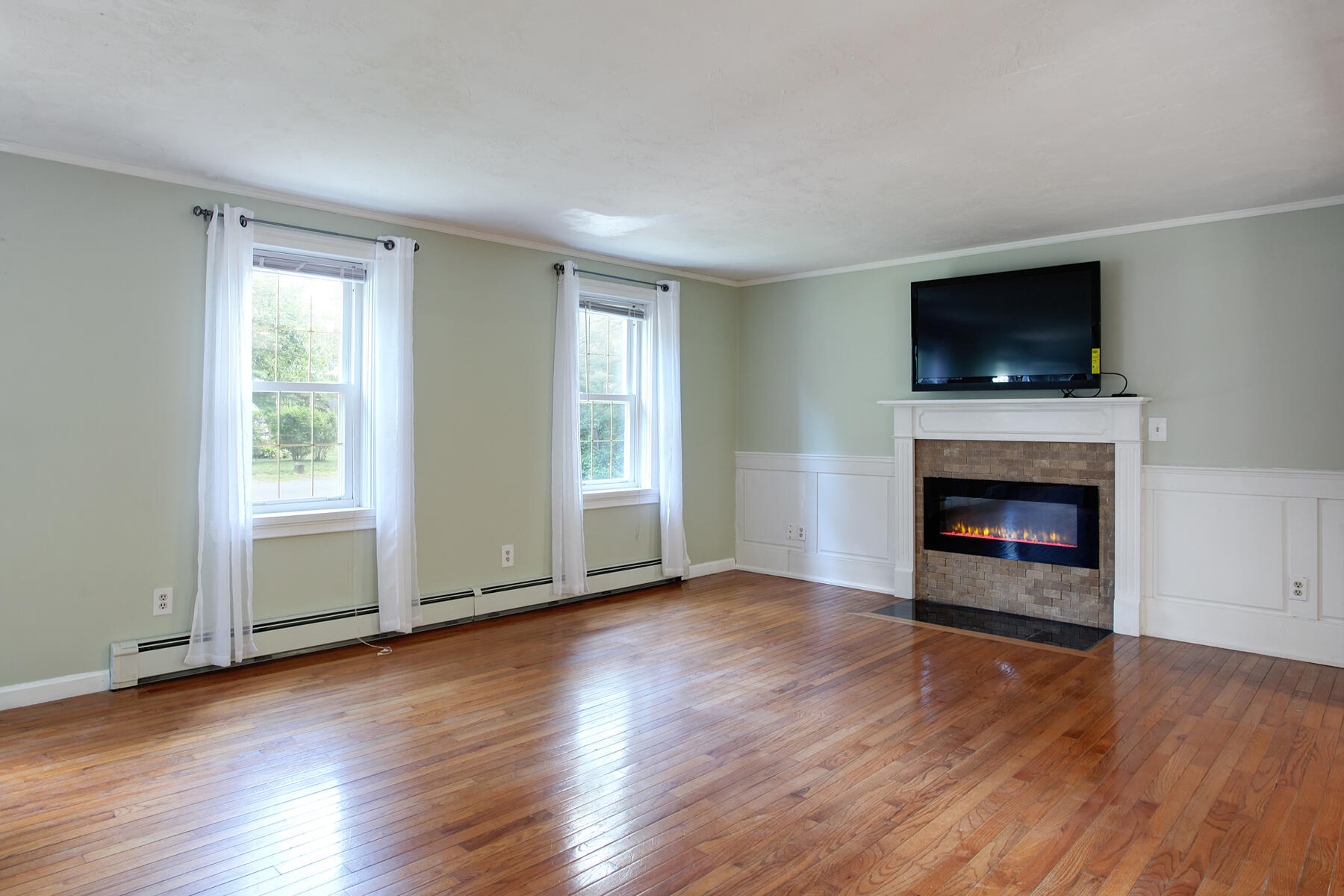 55 Edgewater Road Mashpee, MA 02649 - Photo 6 of 21 a view of an empty room with wooden floor fireplace and a window