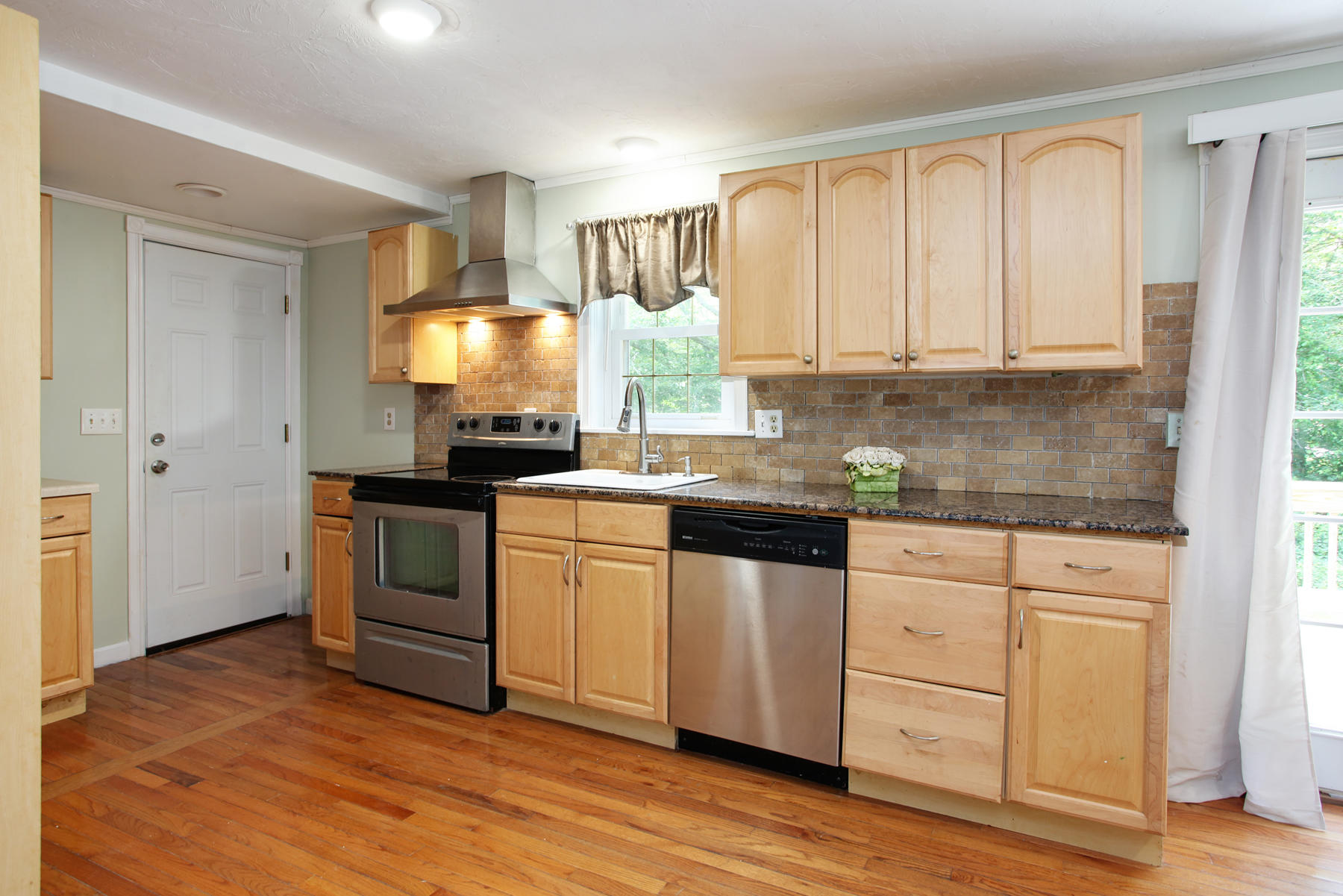55 Edgewater Road Mashpee, MA 02649 - Photo 8 of 21 a kitchen with granite countertop white cabinets and white appliances