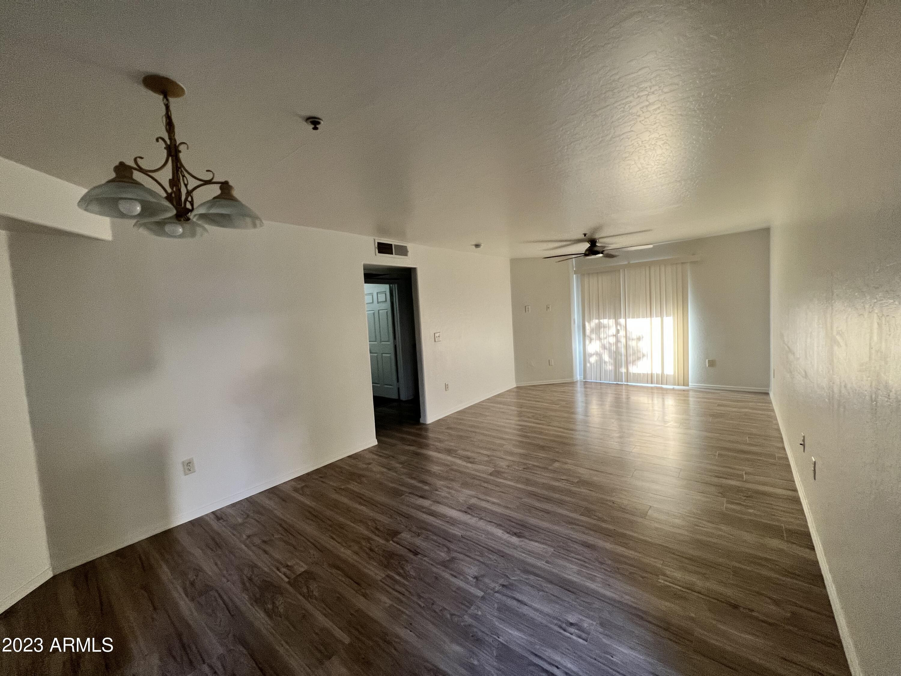 1287 North Alma School Road, Unit 224 Chandler, AZ 85224 - Photo 3 of 8 a view of a room with wooden floor and window