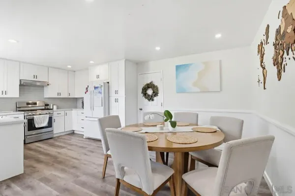 a view of a dining room with furniture and wooden floor