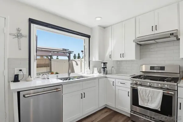 a kitchen with a sink stove and cabinets
