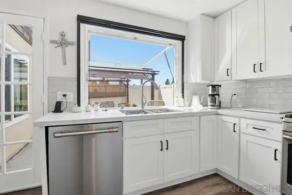 a kitchen with cabinets and window