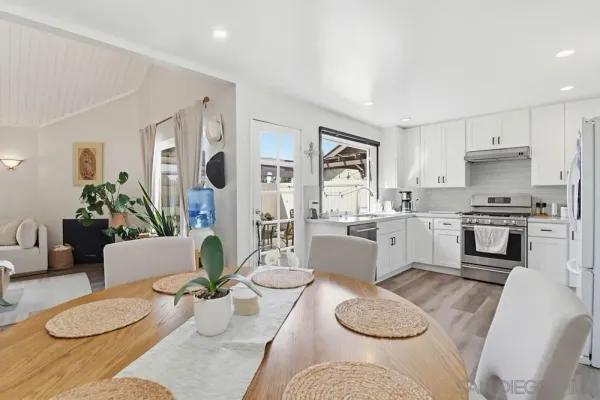 a living room with furniture kitchen and a window