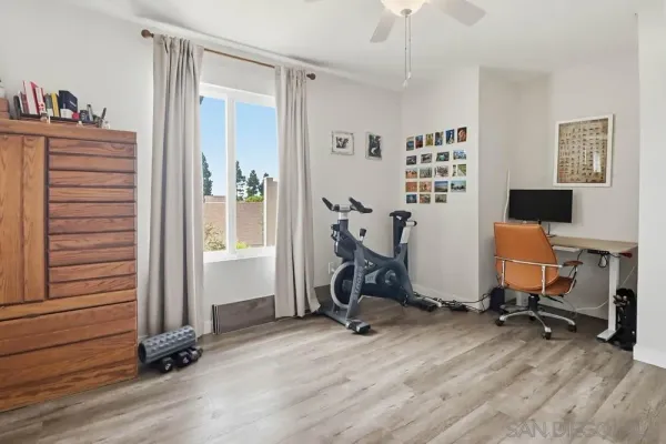 a view of a workspace with furniture and a window